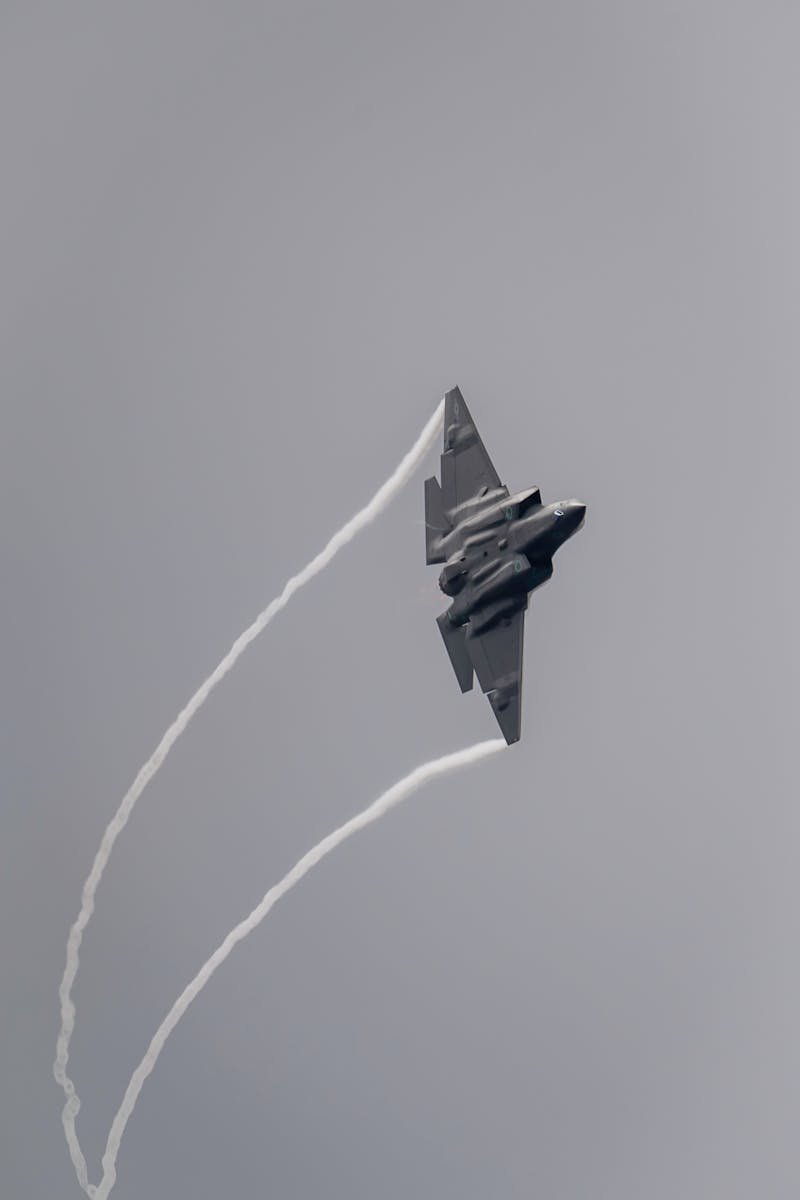 A powerful military jet executing a high-speed aerial maneuver at Huntington Beach airshow.