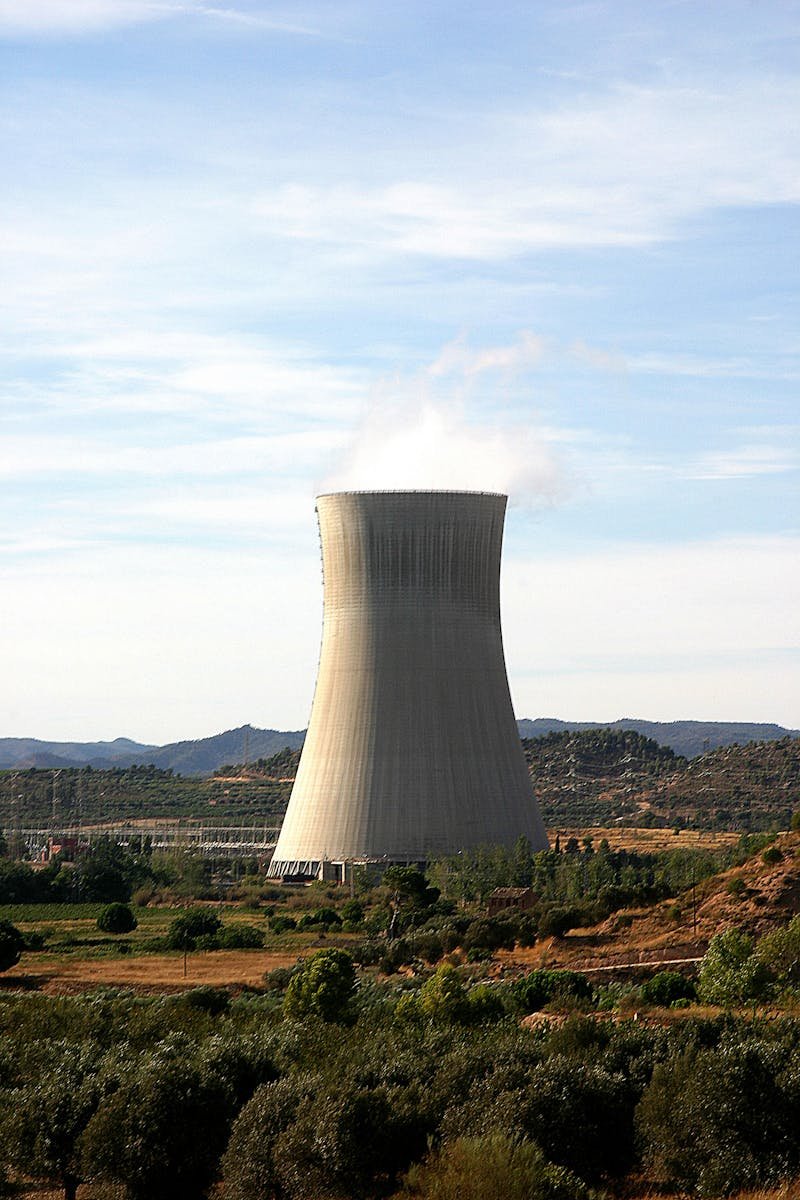 Cooling tower of a nuclear power plant in Ascó, Spain against a rural landscape.
