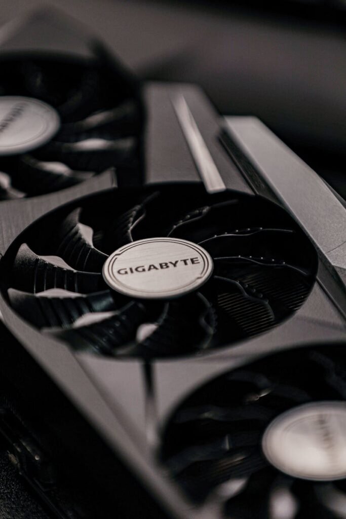 Contemporary specialized electronic black video cards with inscriptions for generating feed of output images to display device placed on table in room